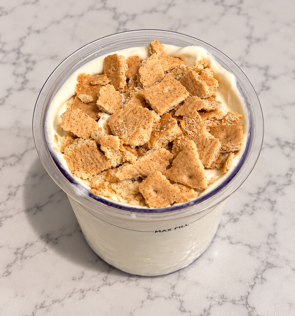 High-Protein Vanilla Pudding Ninja Creami topped with one crushed Honey Maid graham cracker sheet