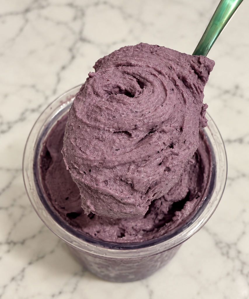 Thick and creamy Blueberry Ninja Creami texture on a green spoon