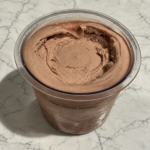 High-Protein Chocolate Ninja Creami in a pint container showing the smooth and creamy chocolate ice cream.
