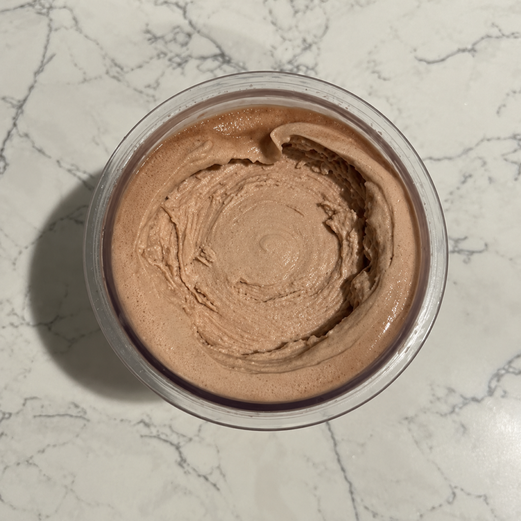 Top-down view of a finished High-Protein Chocolate Ninja Creami pint showing its smooth chocolate ice cream texture.