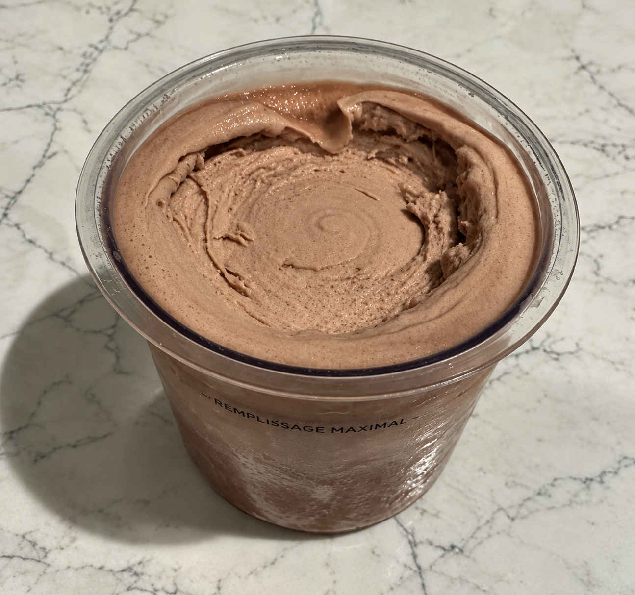 High-Protein Chocolate Ninja Creami in a pint container showing the smooth and creamy chocolate ice cream.