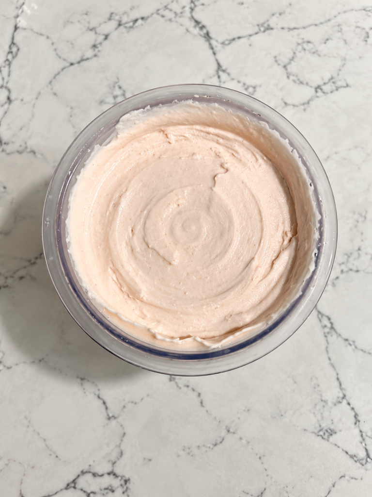Top-down view of High-Protein Strawberry Cheesecake Pudding Ninja Creami in a Ninja Creami pint