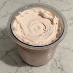 High-Protein Strawberry Ninja Creami with smooth, creamy strawberry ice cream in a Ninja Creami pint.