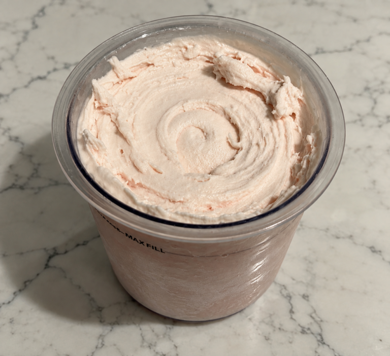 High-Protein Strawberry Ninja Creami with smooth, creamy strawberry ice cream in a Ninja Creami pint.