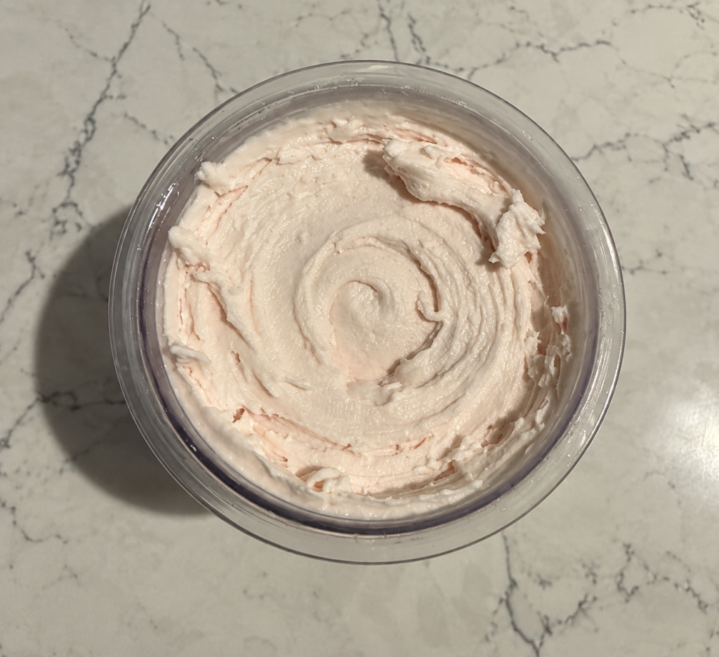 Top-down view of High-Protein Strawberry Ninja Creami showing the creamy strawberry ice cream and swirled texture.