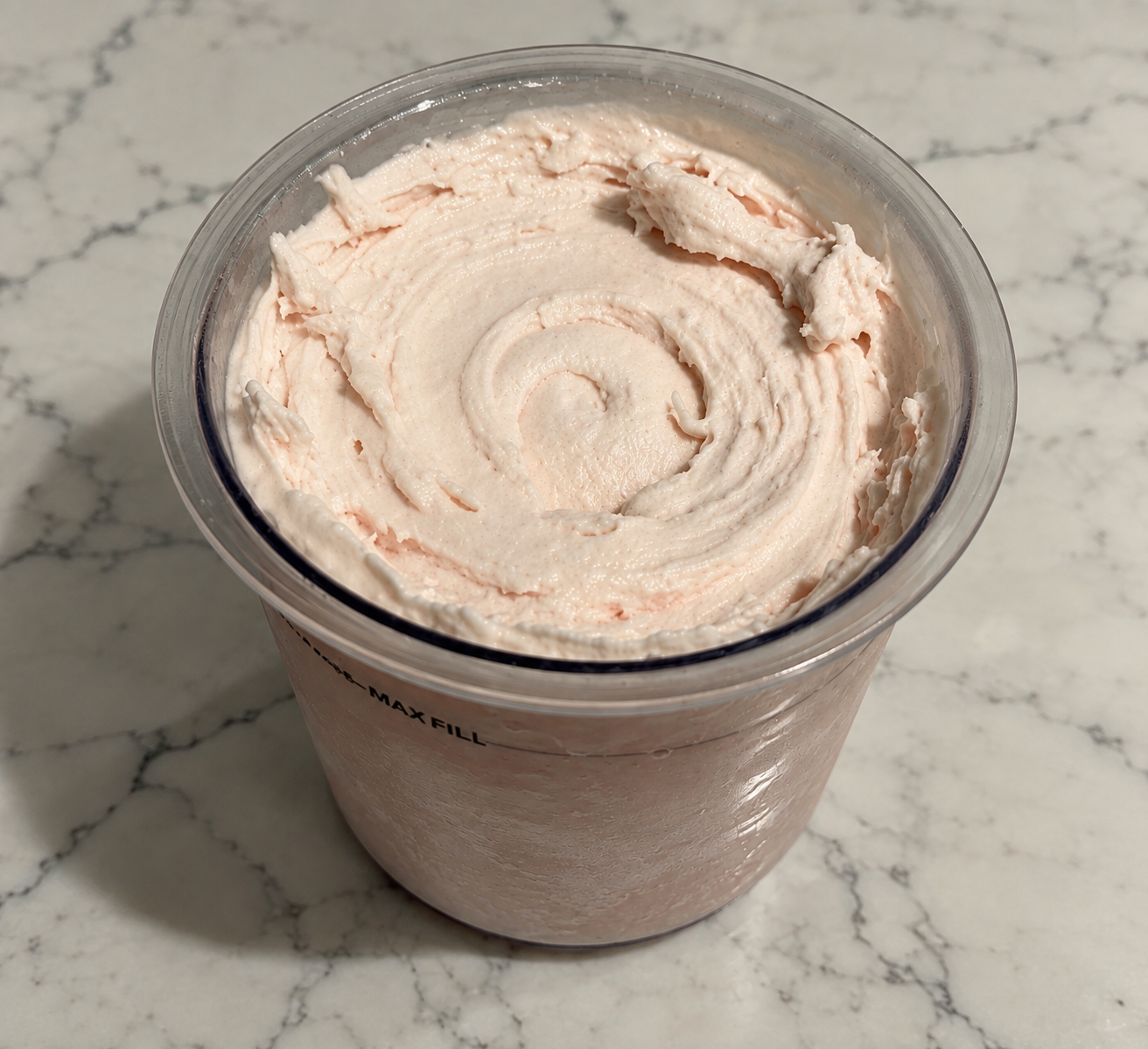 High-Protein Strawberry Ninja Creami with smooth, creamy strawberry ice cream in a Ninja Creami pint.