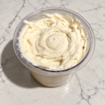 High-Protein Vanilla Ninja Creami with smooth, creamy vanilla ice cream in a Ninja Creami pint.