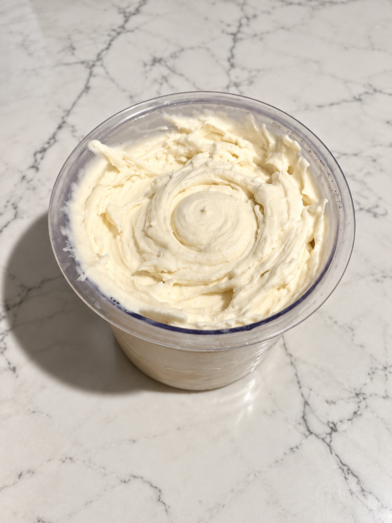 High-Protein Vanilla Ninja Creami with smooth, creamy vanilla ice cream in a Ninja Creami pint.