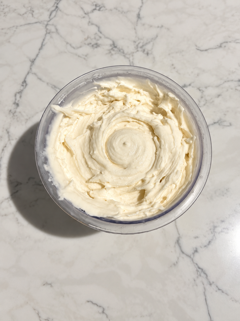 Top-down view of High-Protein Vanilla Ninja Creami showing the smooth vanilla ice cream and creamy swirled texture.