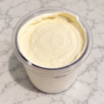 High-Protein Vanilla Pudding Ninja Creami with a smooth, creamy vanilla texture in a Ninja Creami pint
