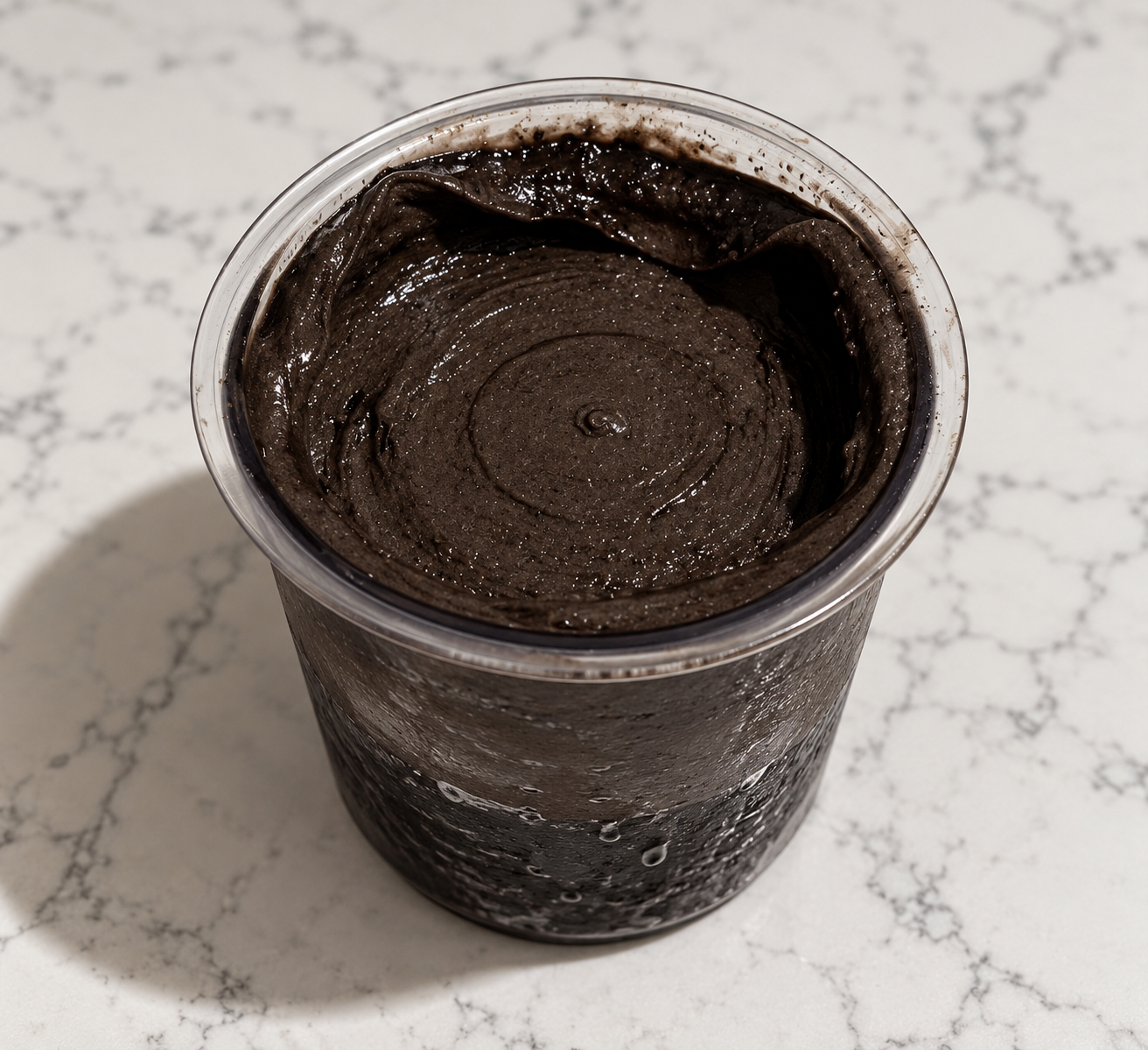 Dark Chocolate Ninja Creami made without protein powder in a clear pint container.