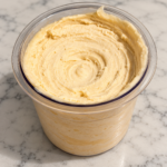 Creamy butterscotch Ninja Creami ice cream in a clear pint container, made without protein powder.