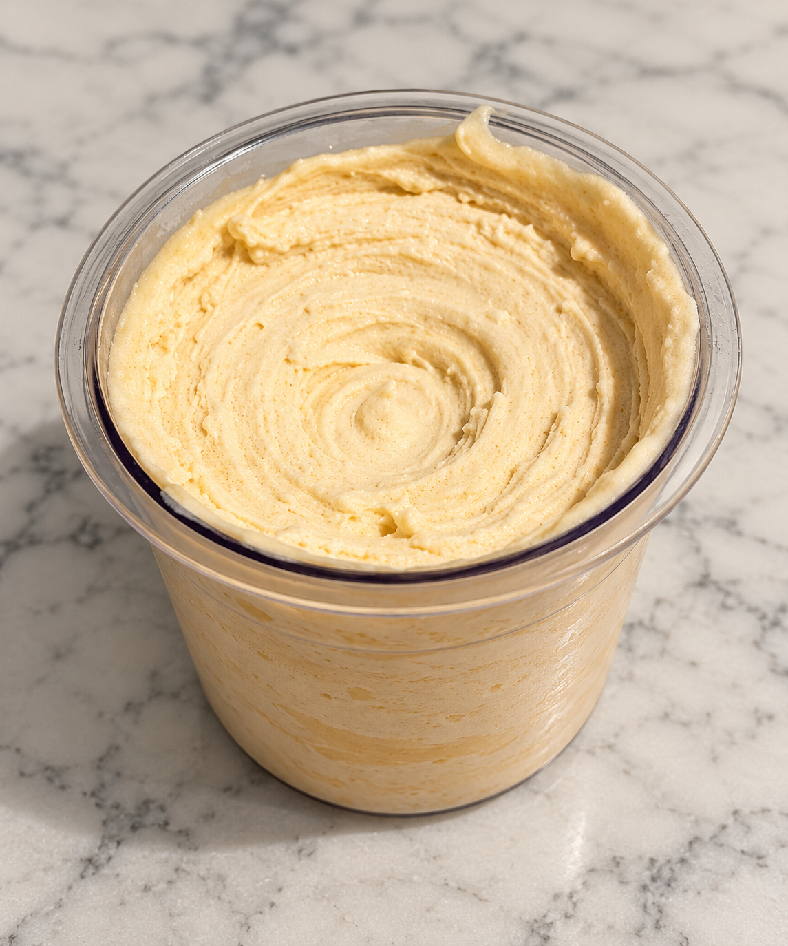 Creamy butterscotch Ninja Creami ice cream in a clear pint container, made without protein powder.